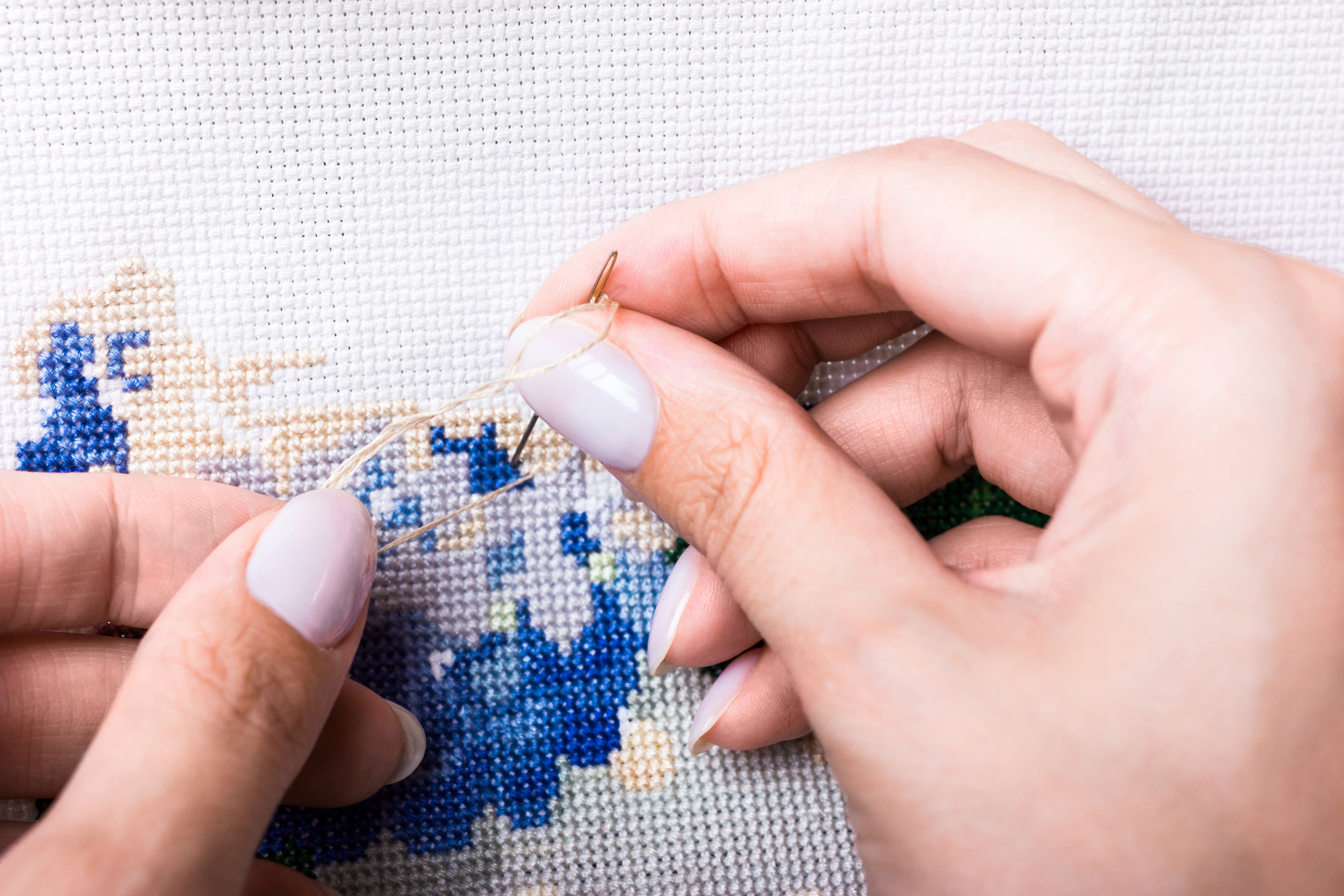 Smaller portrait of hands stitching bold pattern